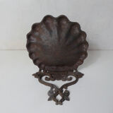 Old cast iron planter shell-shaped plant support