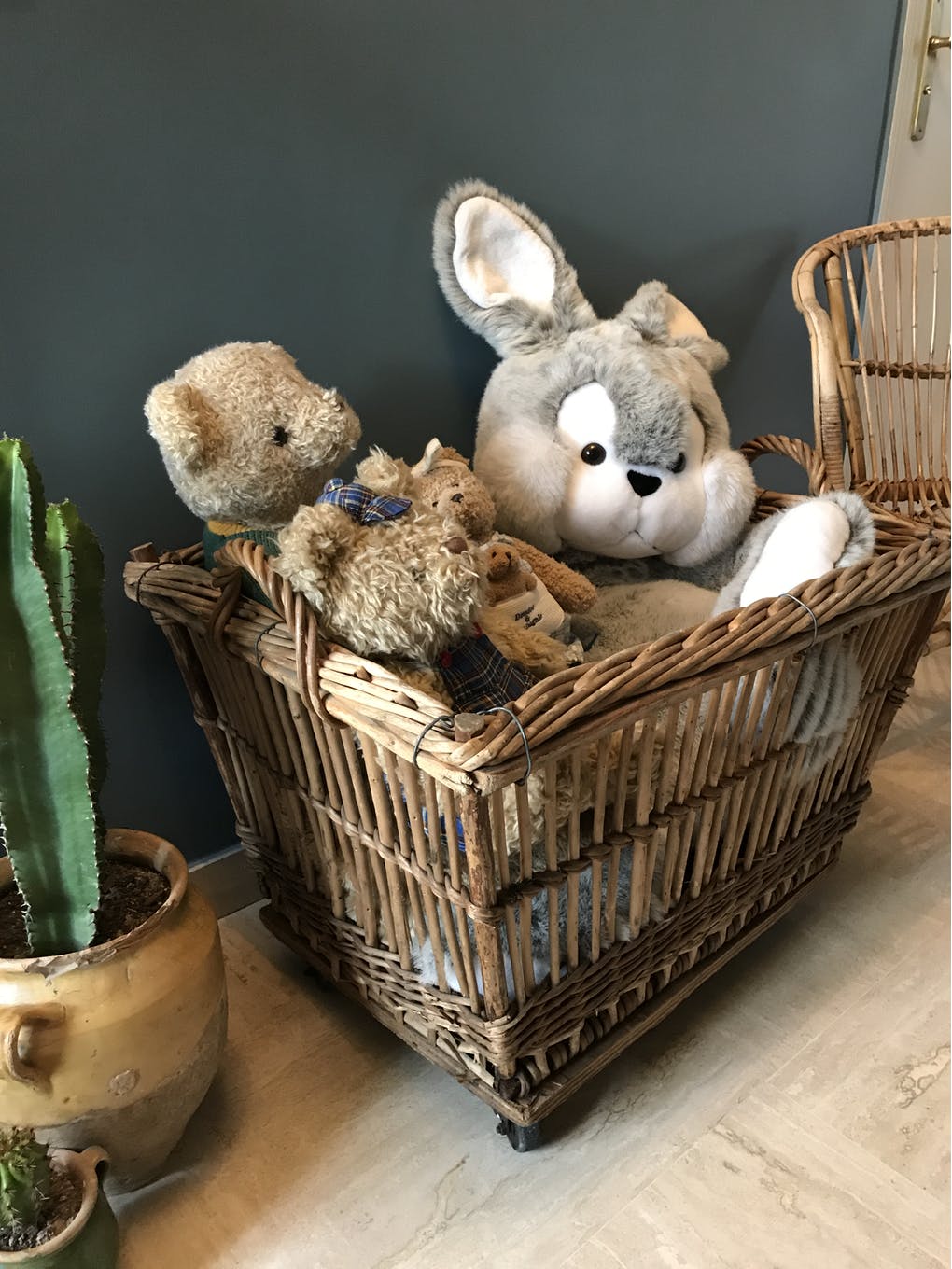 Rattan laundry basket on vintage wheels