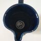 Vintage pitcher in midnight blue glazed ceramic with bright pink relief
