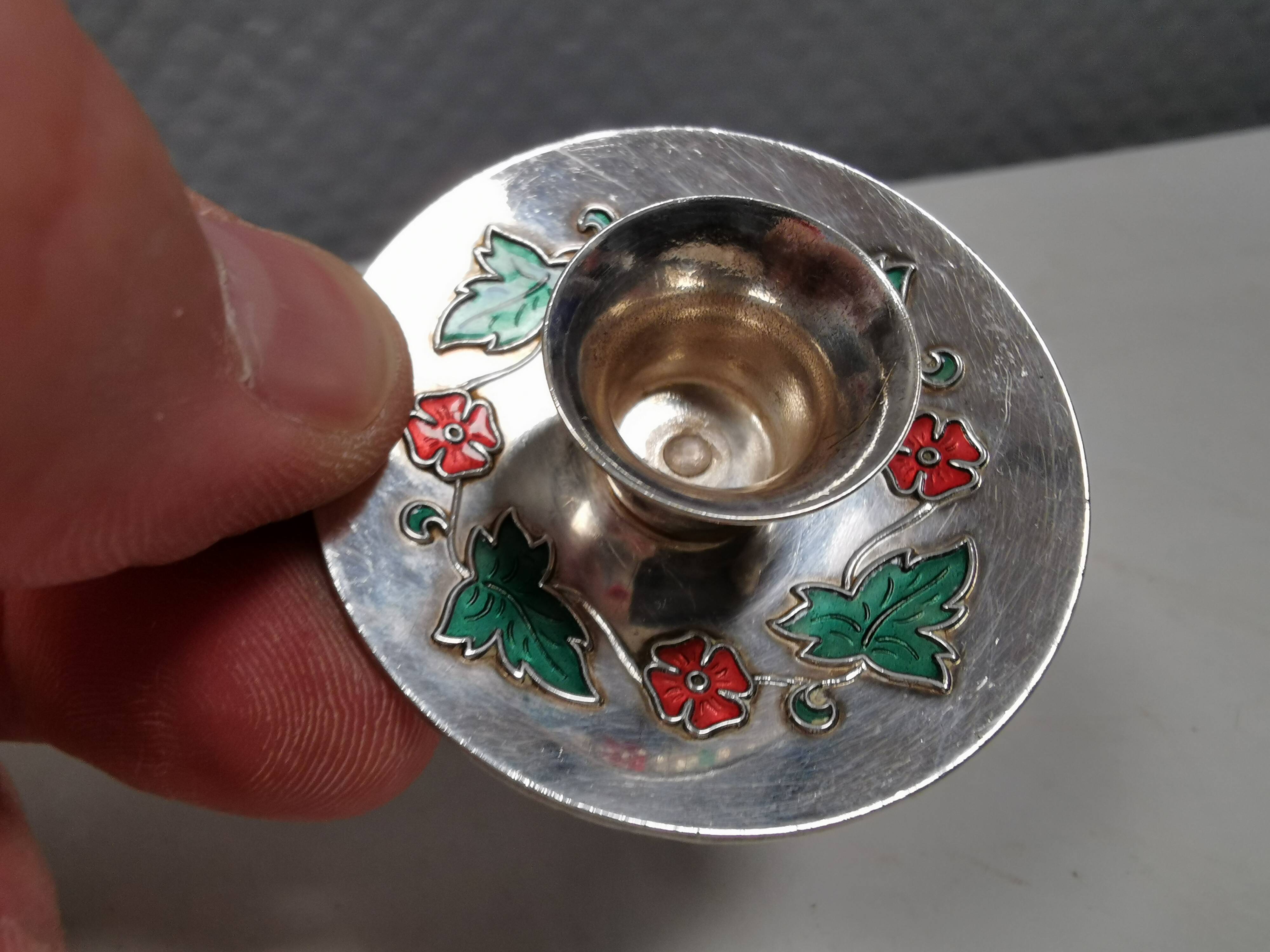 Silver-plated candle holders with inlaid red and green enamel