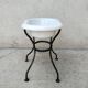 Antique bidet in enamelled sheet metal with wrought iron support