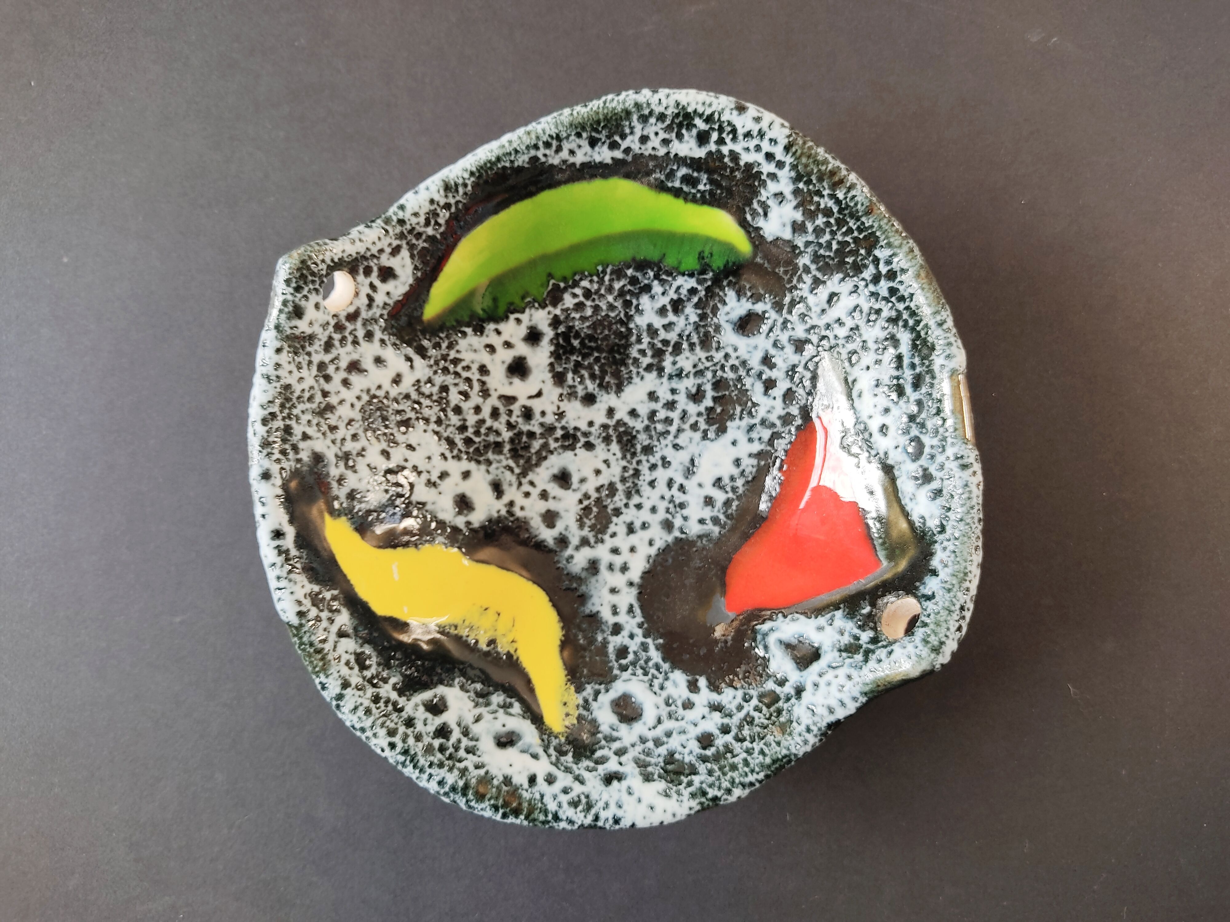 Empty black and white pocket with colored enamels