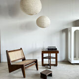 Reclined armchair in canned teak in natural wood