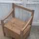 Antique armchair in raw wood