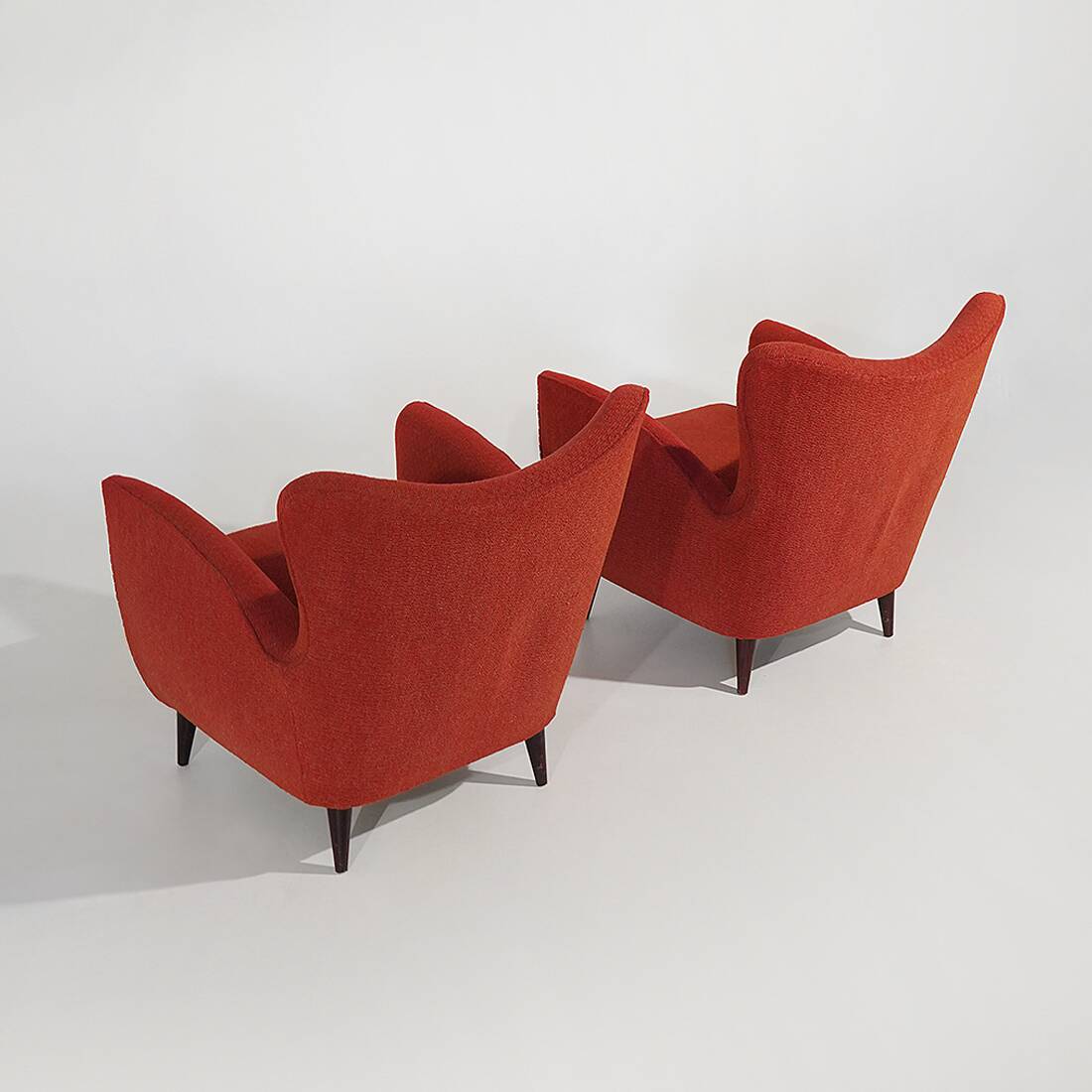 Pair of red armchairs with cone-shaped feet, 1950s