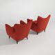 Pair of red armchairs with cone-shaped feet, 1950s