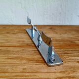 Vintage chrome wall coat rack with three hooks.