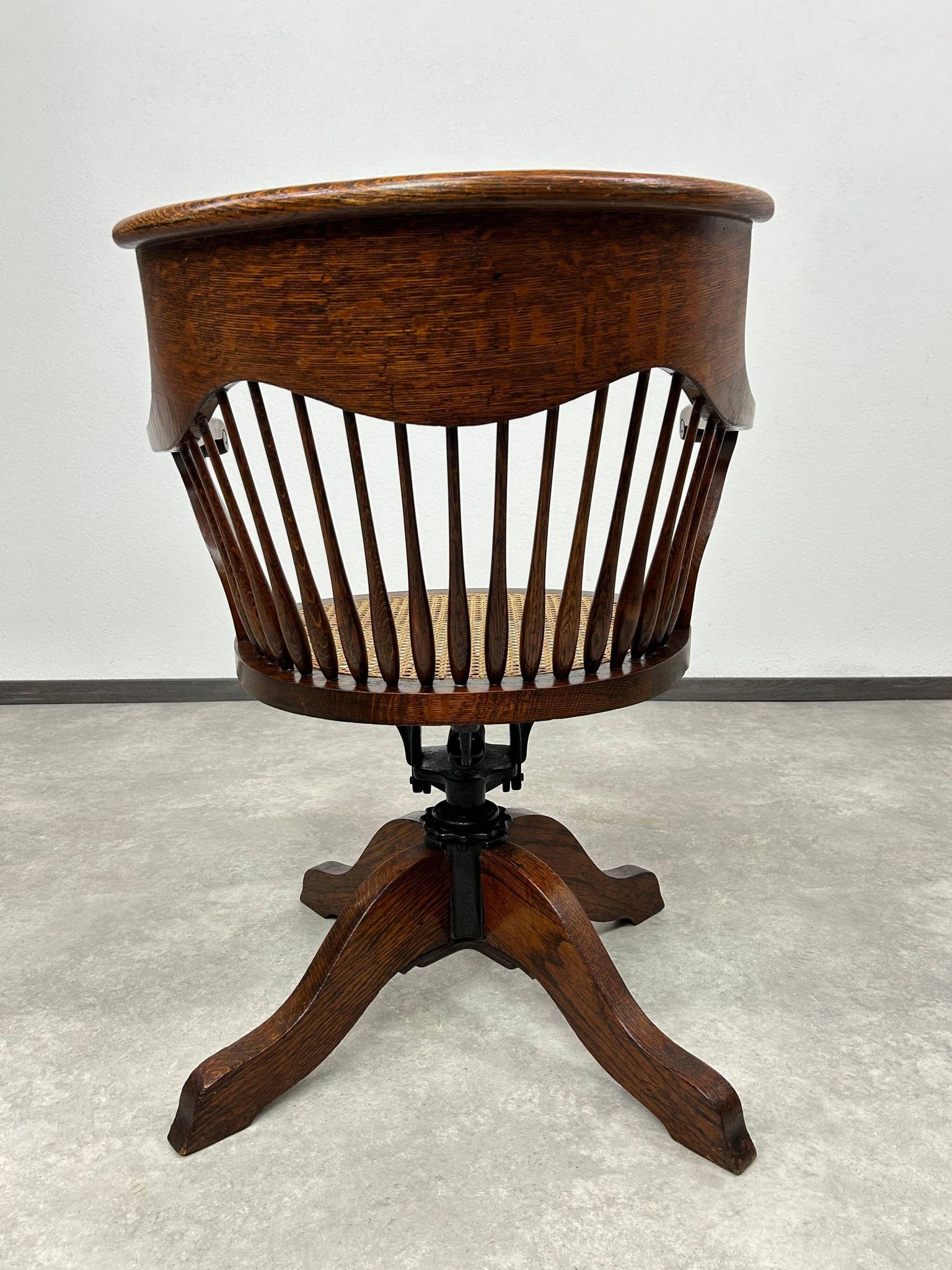 Swivel office chair in oak with a rattan seat.