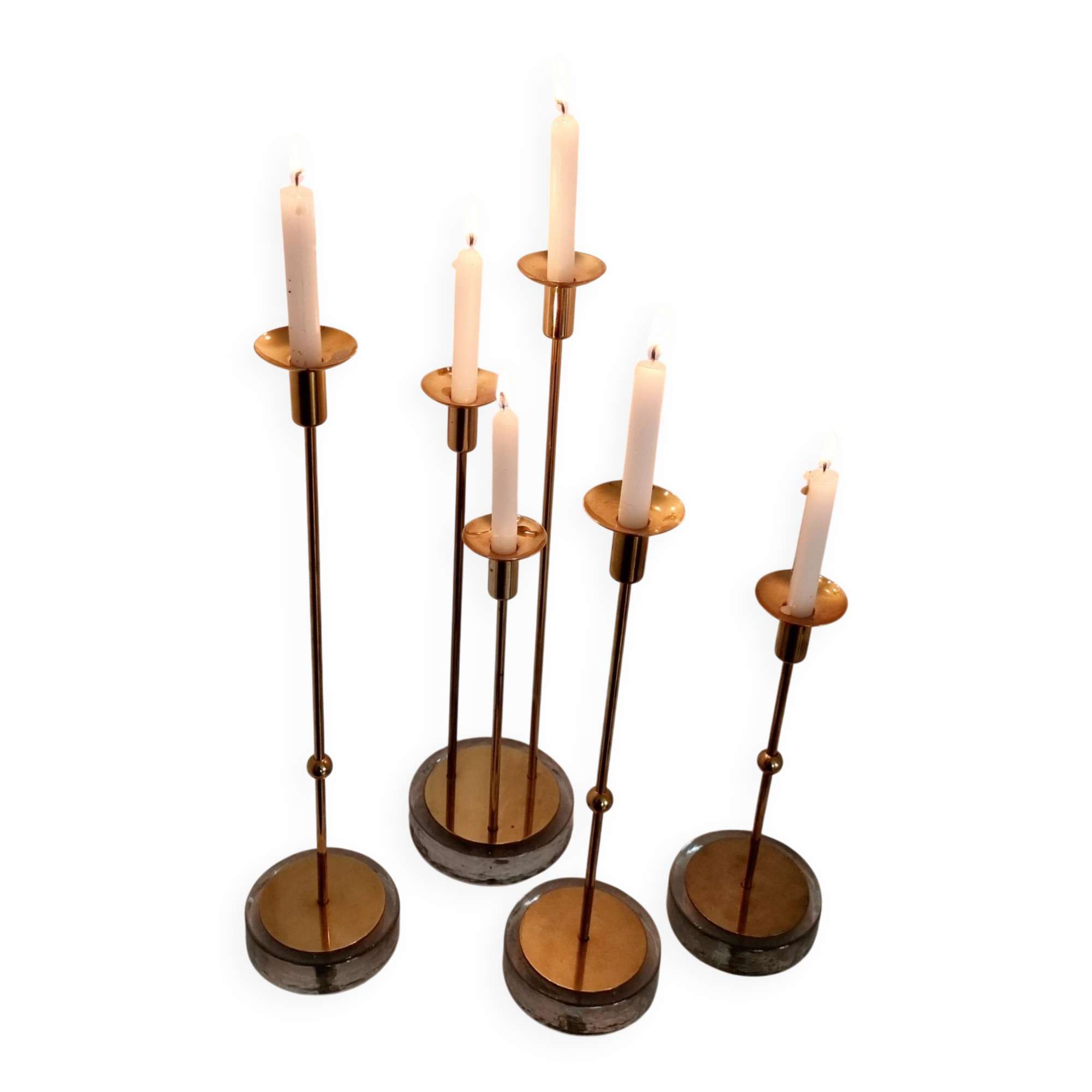 Gunnar Ander, four candlesticks, brass and glass, Ystad Metall, Swedish modern.