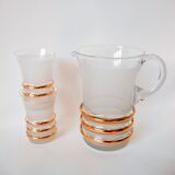 set composed of a pitcher and two large white granite glasses with gold edging from the 60s