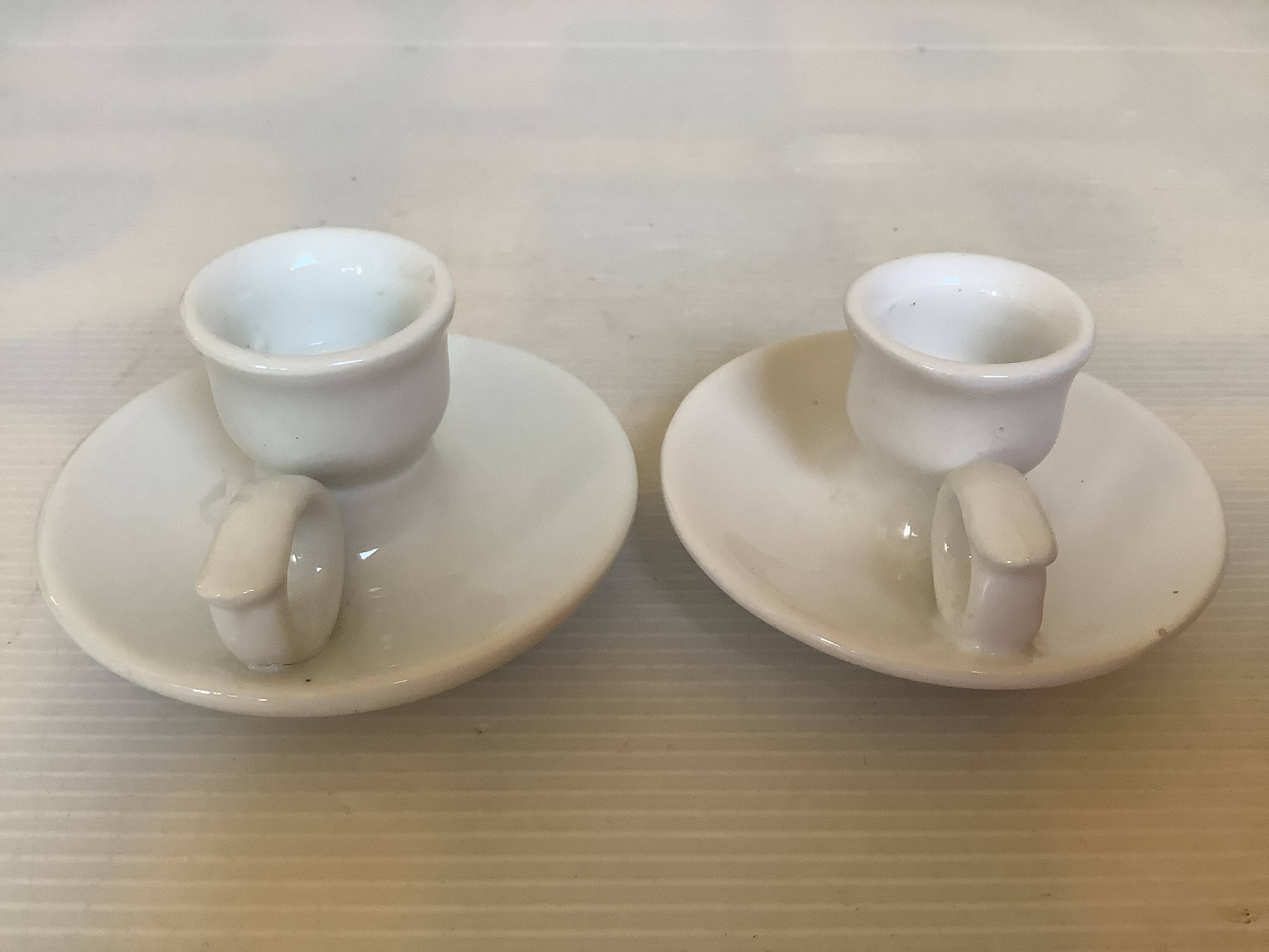 Pair of small white cellar rat candlesticks