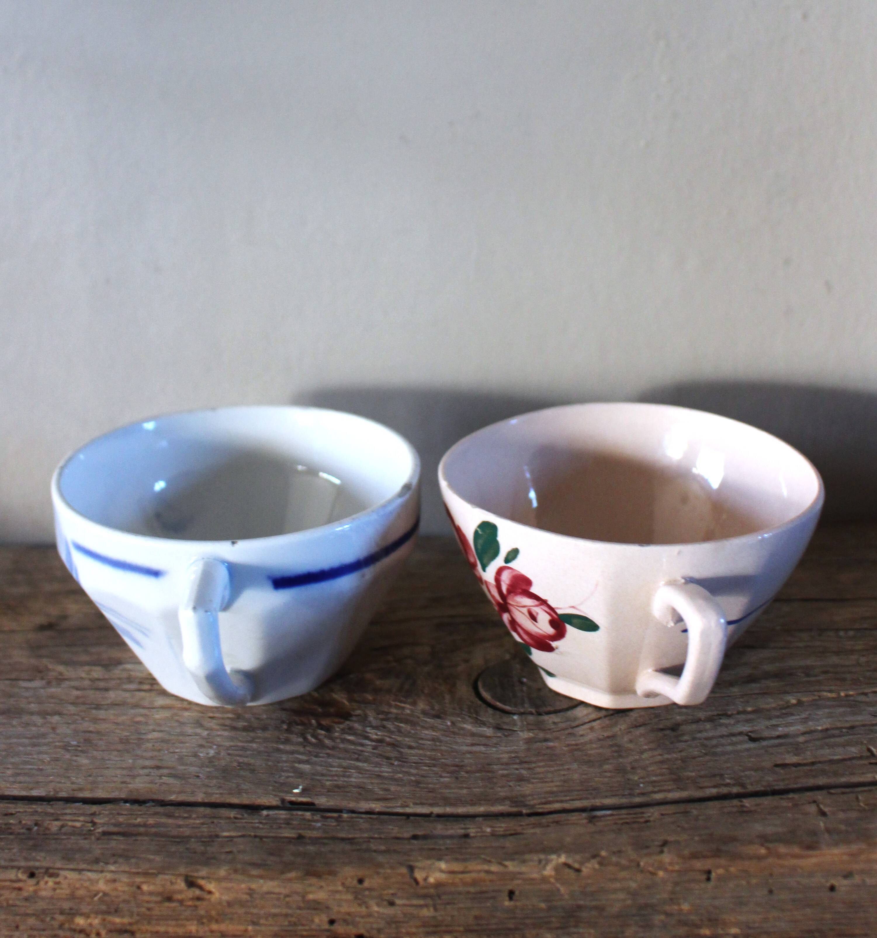 A set of 2 Digoin Sarreguemines cups with pink and blue flowers.