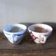 A set of 2 Digoin Sarreguemines cups with pink and blue flowers.