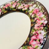 Vintage enameled metal hand mirror on wood
