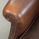 Subtle sheepskin wingback armchair with a deep cognac colour