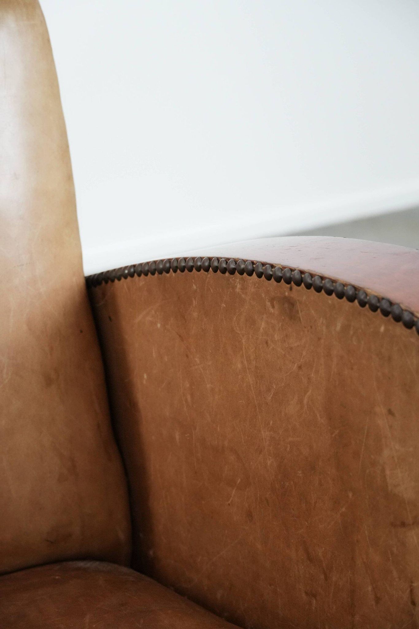 Art Deco design armchair in light cognac cowhide leather.