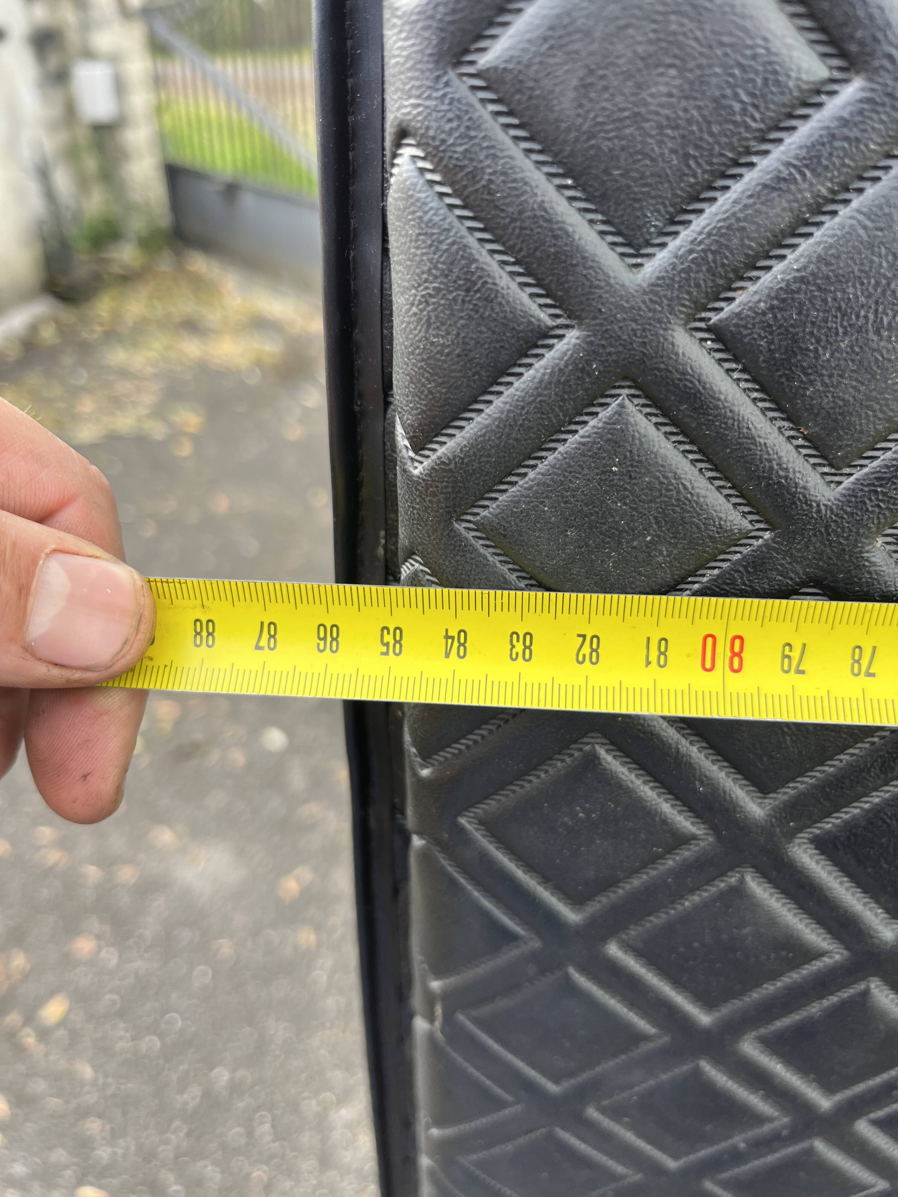 Contemporary wardrobe in black faux leather with diamond pattern and gold handles.