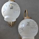 Pair of engraved glass wall lamps, brass support