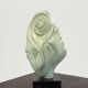 Green natural stone sculpture on marble base