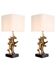 Pair of patinated brass table lamps with black granite base.