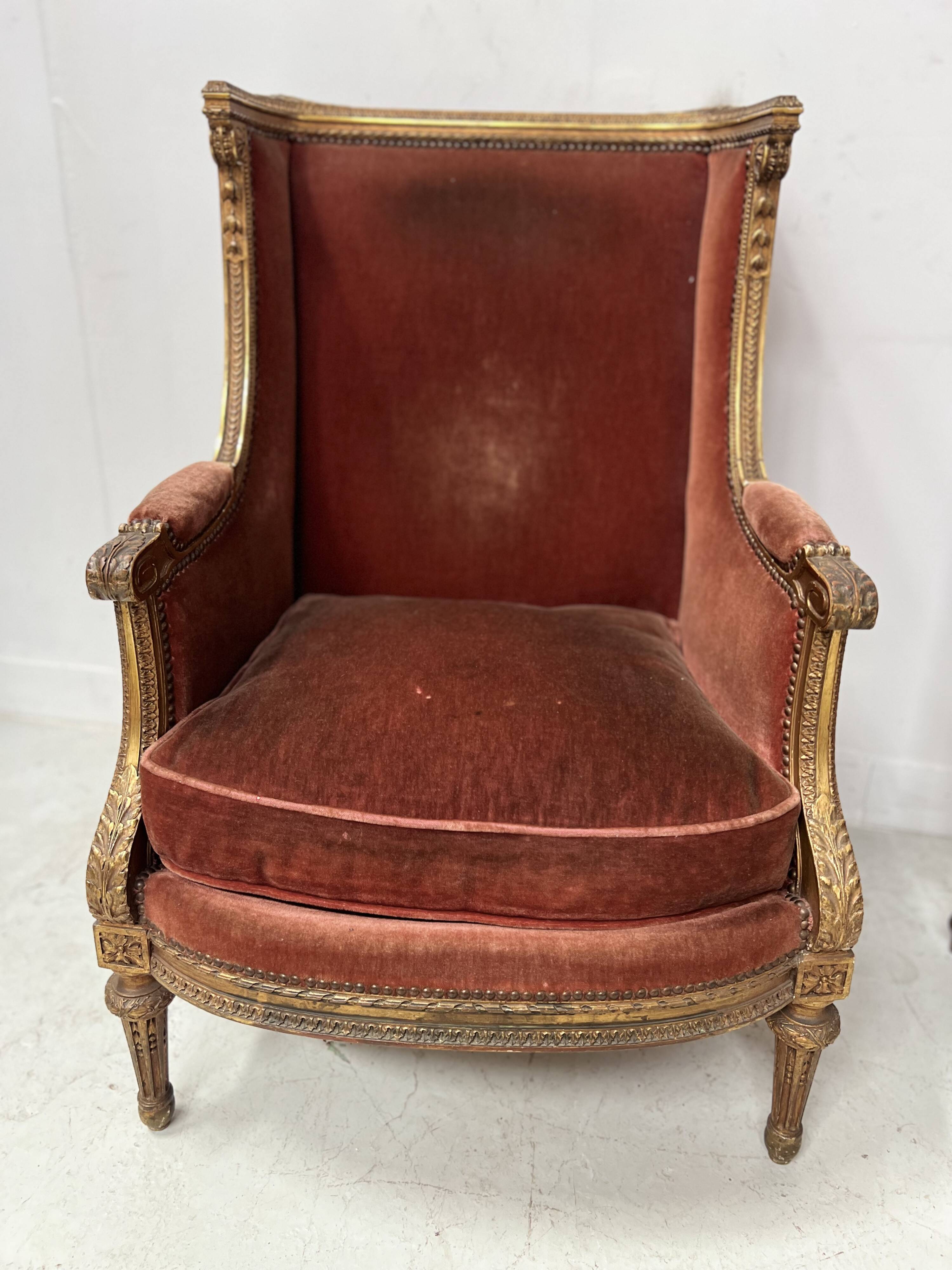 Two Louis XVI style wing chairs in gilded wood, 20th century