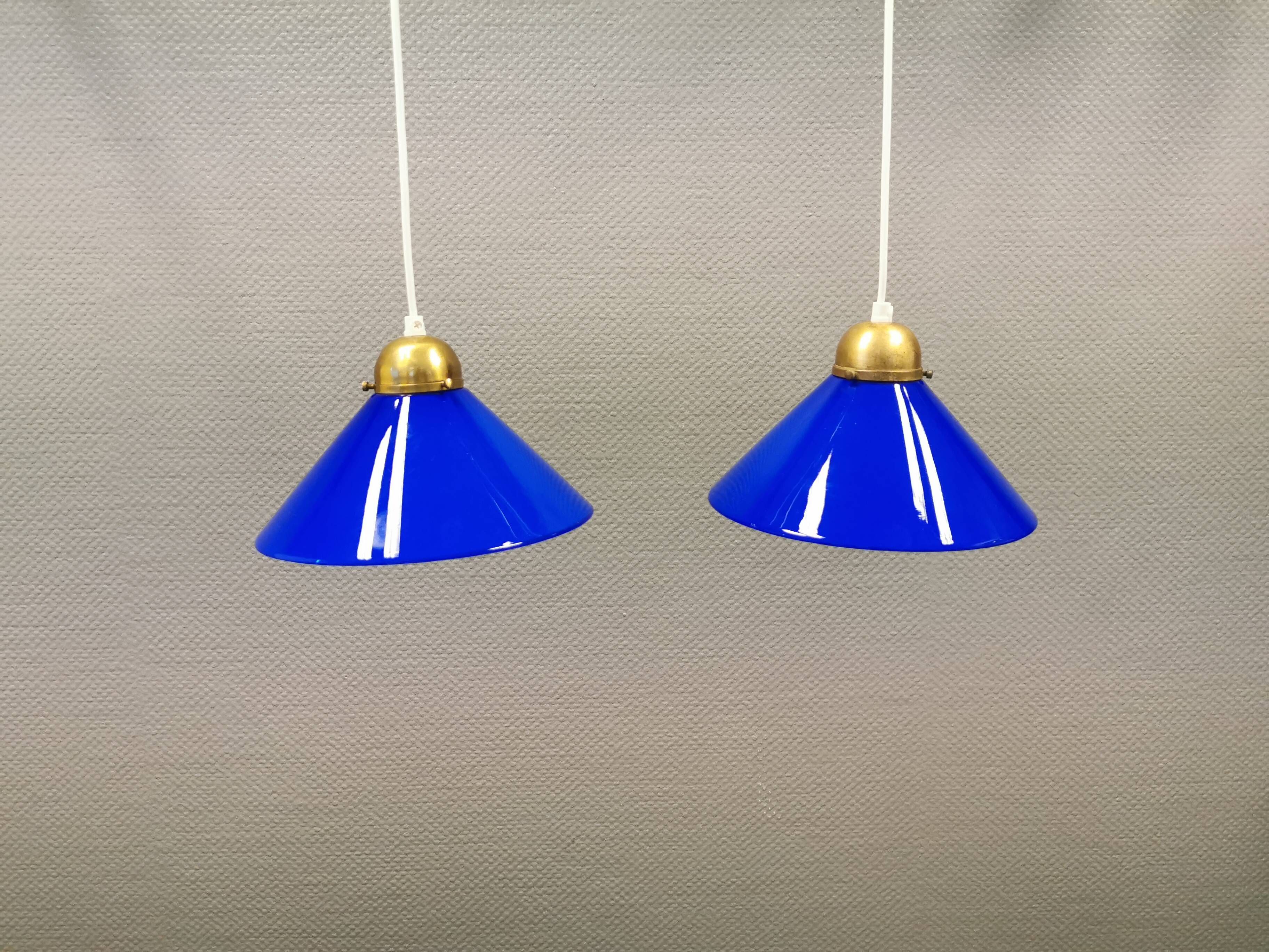 Two lamps in double layered glass with brass top. Danish and estimated from the 1960s