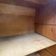 Oak two-column filing cabinet with curtains.