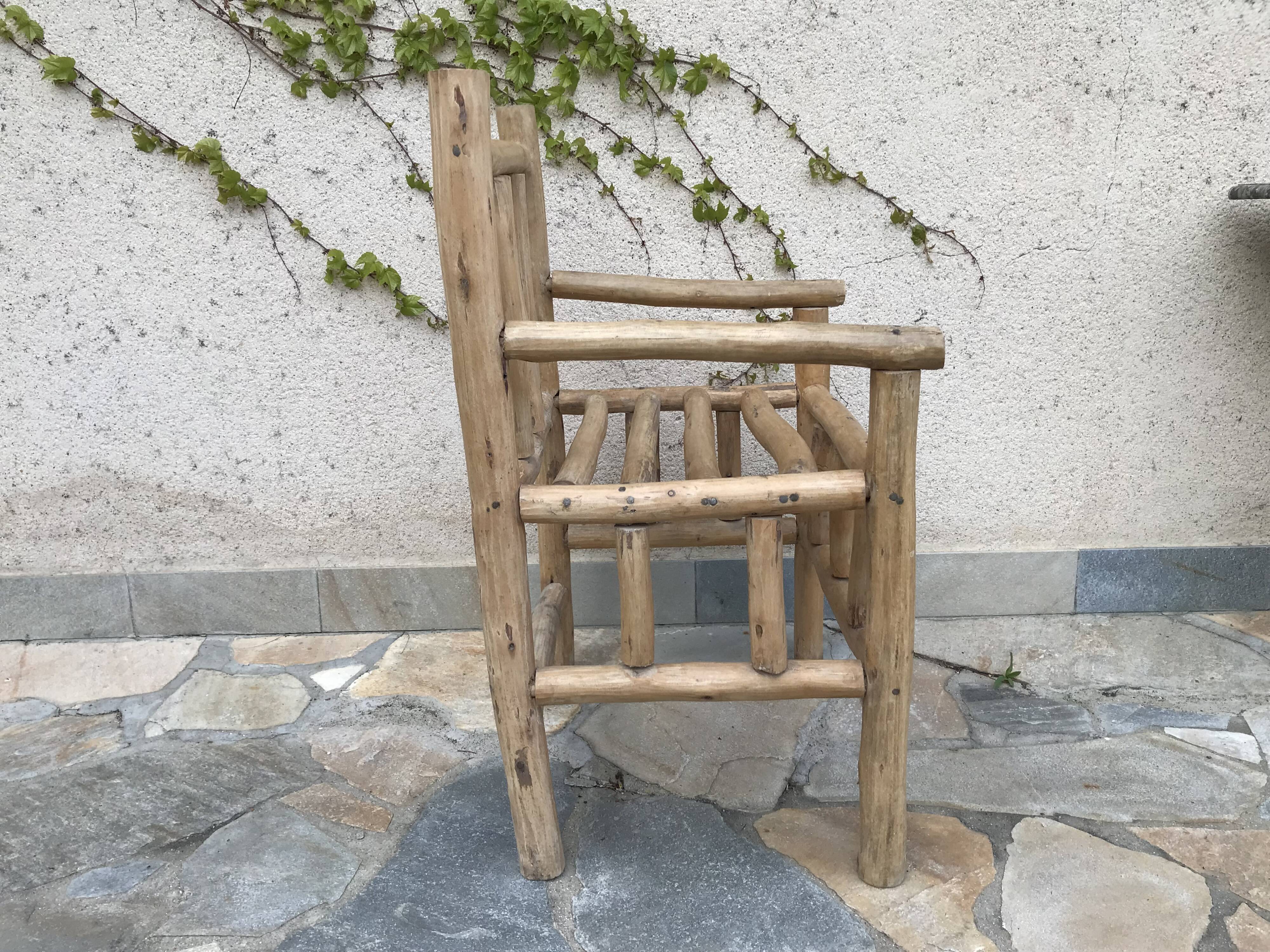 Art-Populaire armchair in raw wood, circa 1950.