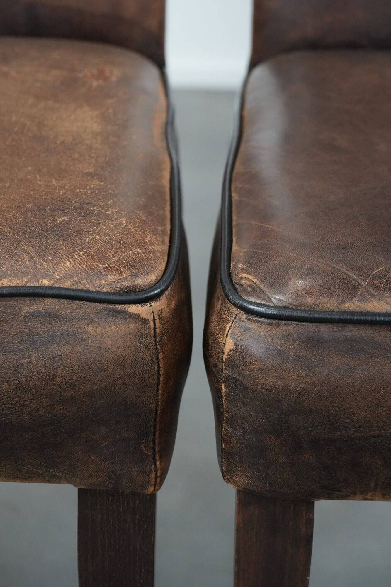 Set of 6 vintage sheepskin dining chairs finished with black piping