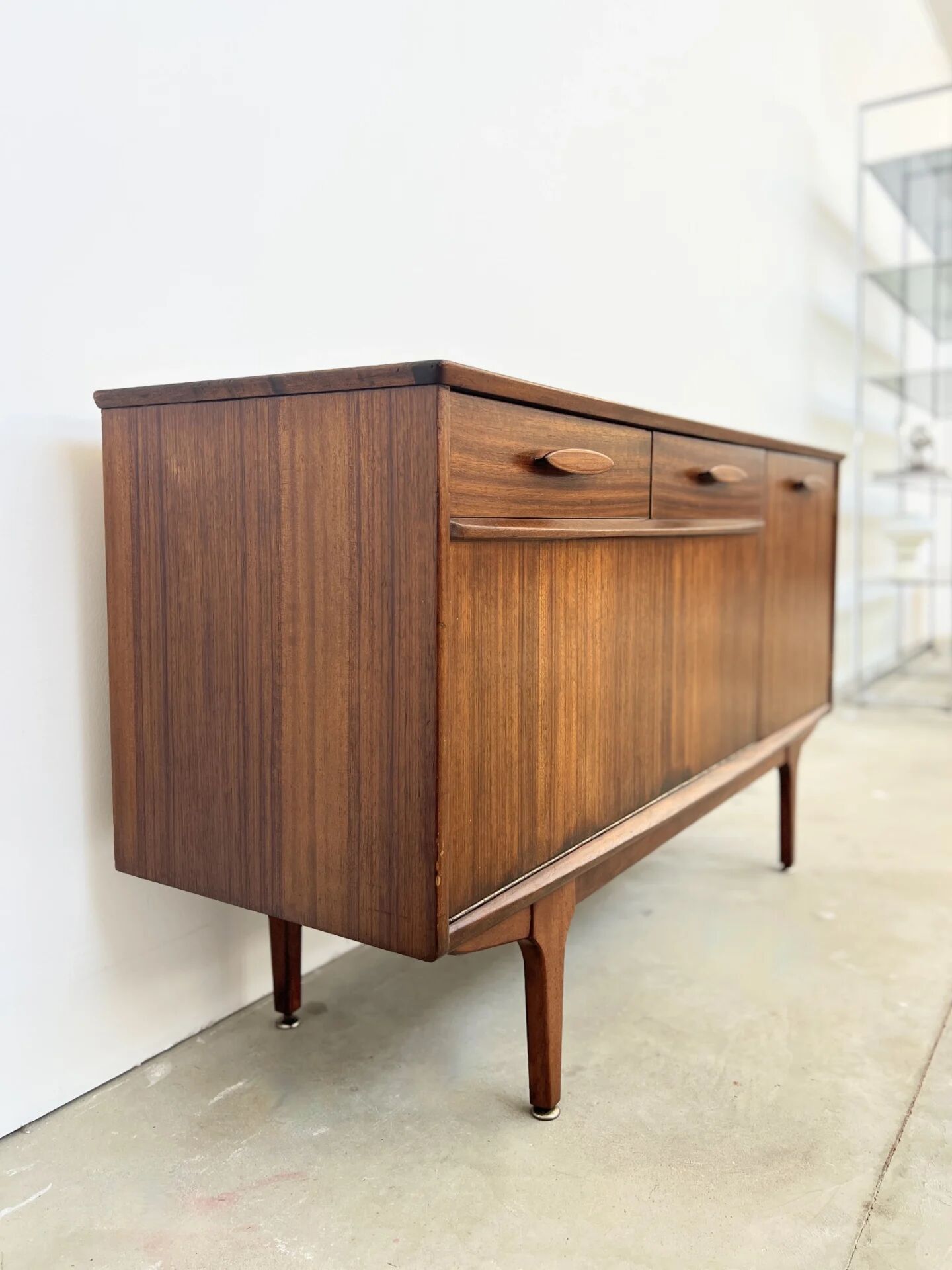 Teak Jentique sideboard — 1 door, 2 drawers & drop-down bar, England 1950s-60s