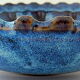 Cut or pocket in polychrome varnished sandstone with a blue and floral decoration