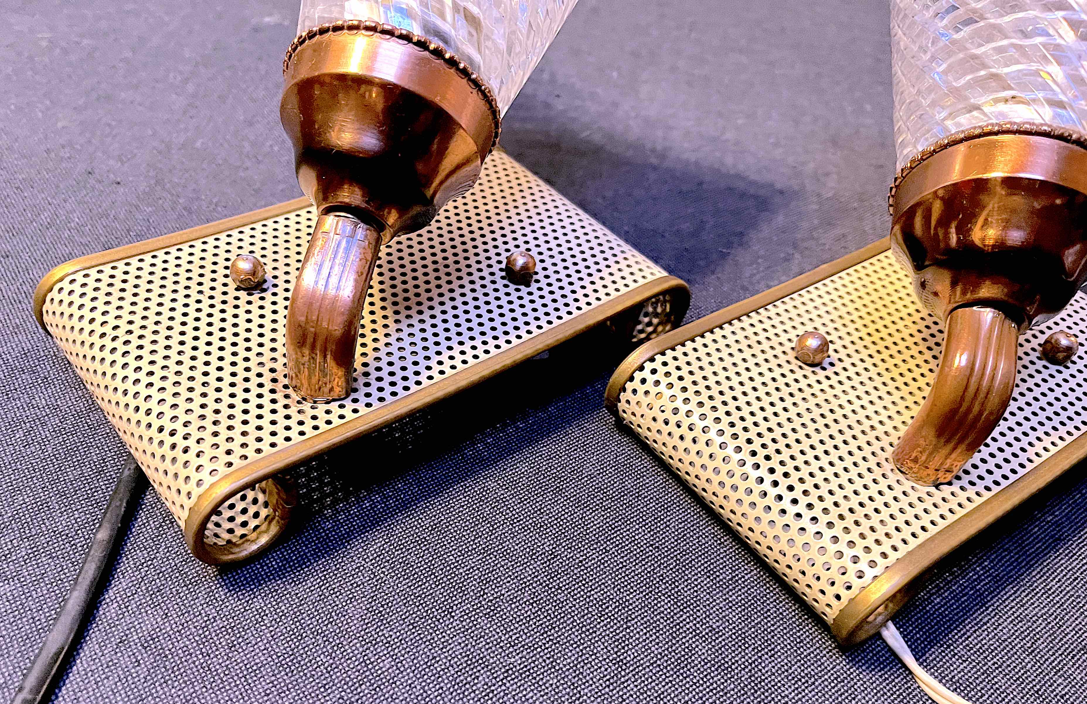 Pair of brass sconces, perforated metal and perhapx conical lampshade, France 50's