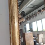 Long wooden mirror and gilded stucco with pearl rays H: 2m45 L: 40cm