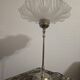 Table lamp with a silver base and a frilled shade.
