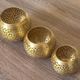 Set of 3 handmade brass candle holders with an openwork pattern.