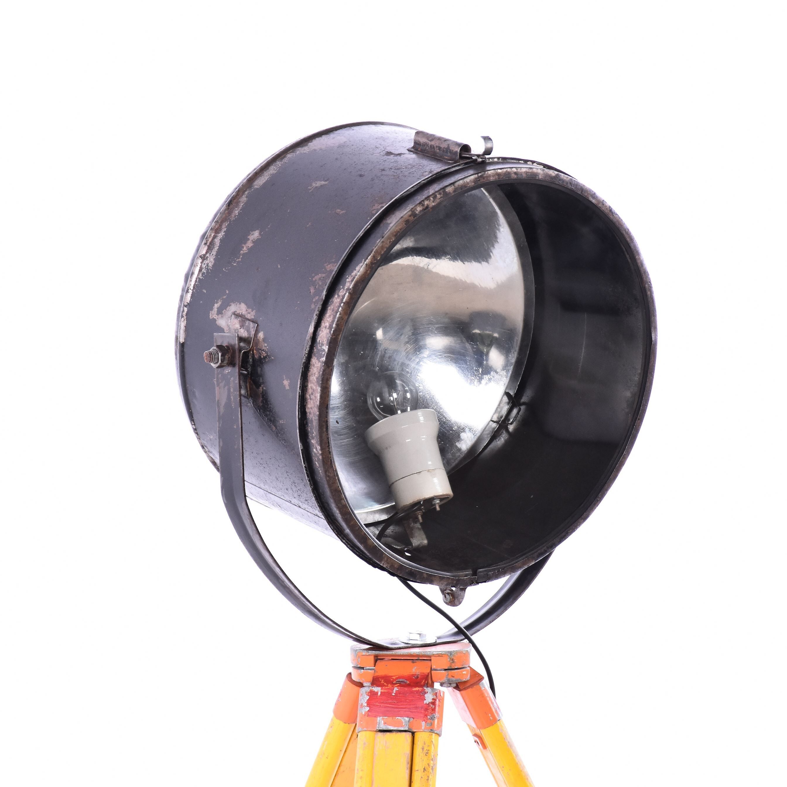 Old industrial spot on wooden tripod