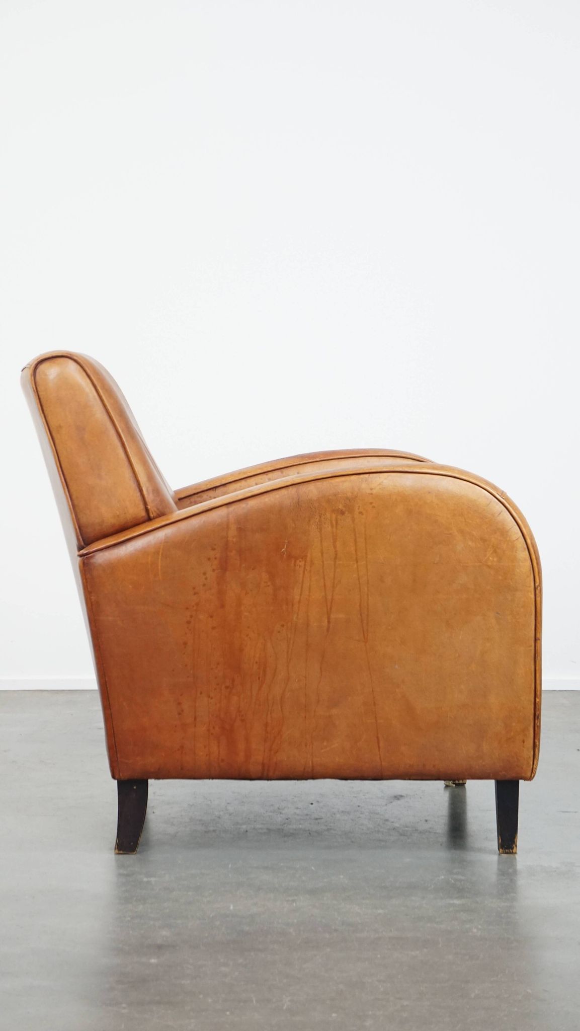 Characteristic sheepskin design armchair in beautiful warm cognac colours