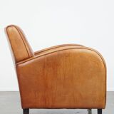 Characteristic sheepskin design armchair in beautiful warm cognac colours