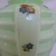Ancient green opaline crystal vase decorated with small multicolored flowers