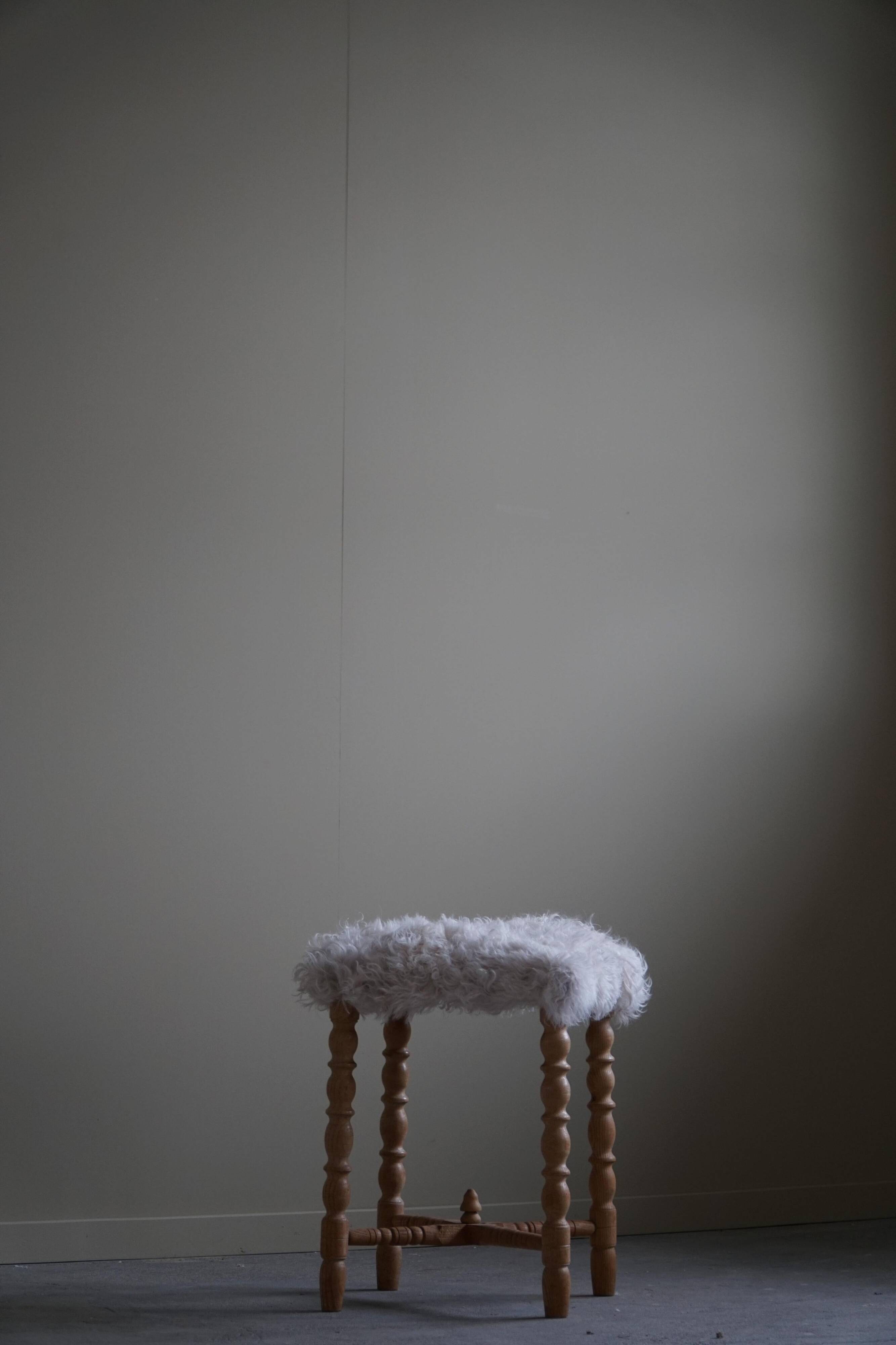 High oak stool, reupholstered in lambswool, Danish cabinetmaker, 1950s.