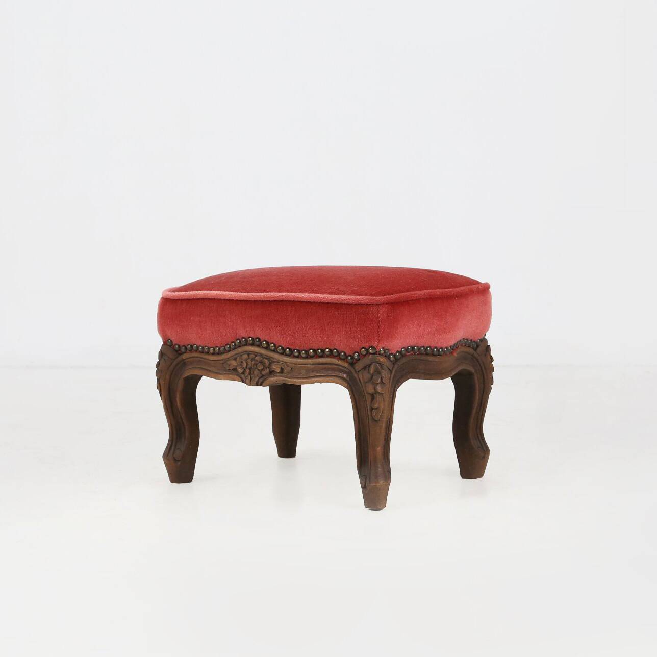 Baroque style foot stool in carved wood with coral velvet upholstery