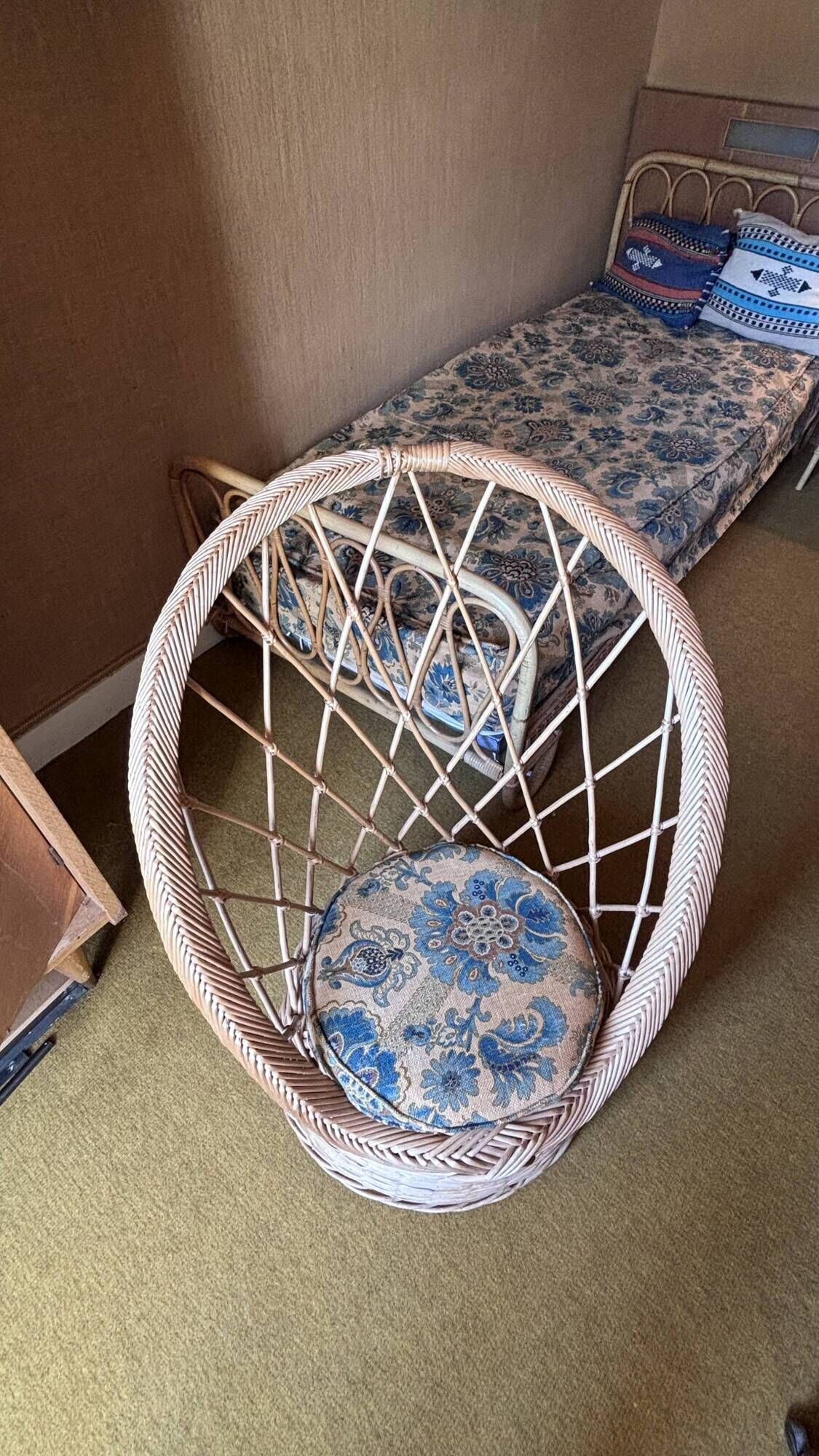 Vintage shell chair in woven rattan with original cushion.