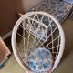 Vintage shell chair in woven rattan with original cushion.