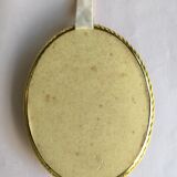 Old medallion frame of dried flowers of oval shape. To hang with velvet stripe.