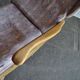 Vintage brown wooden rocking chair from the 1950s, wingback backrest and rocking base.