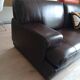 Two brown leather Crozatier two-and-a-half-seater sofas.
