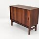 Low sideboard in rosewood with sliding doors. Denmark, 1960s