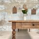 Vintage farmhouse table with turned legs.