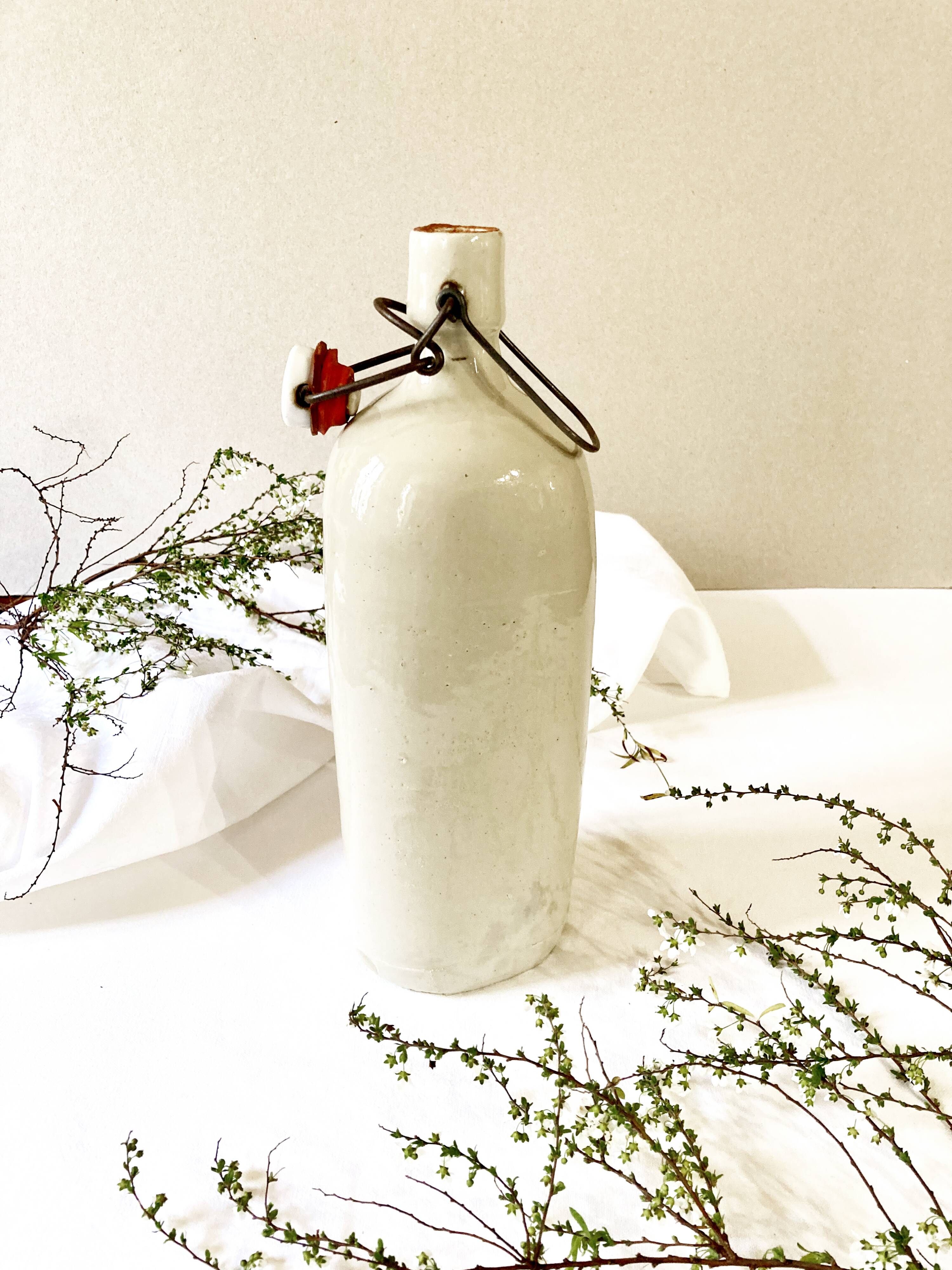 Old light gray enamelled stoneware hot water bottle