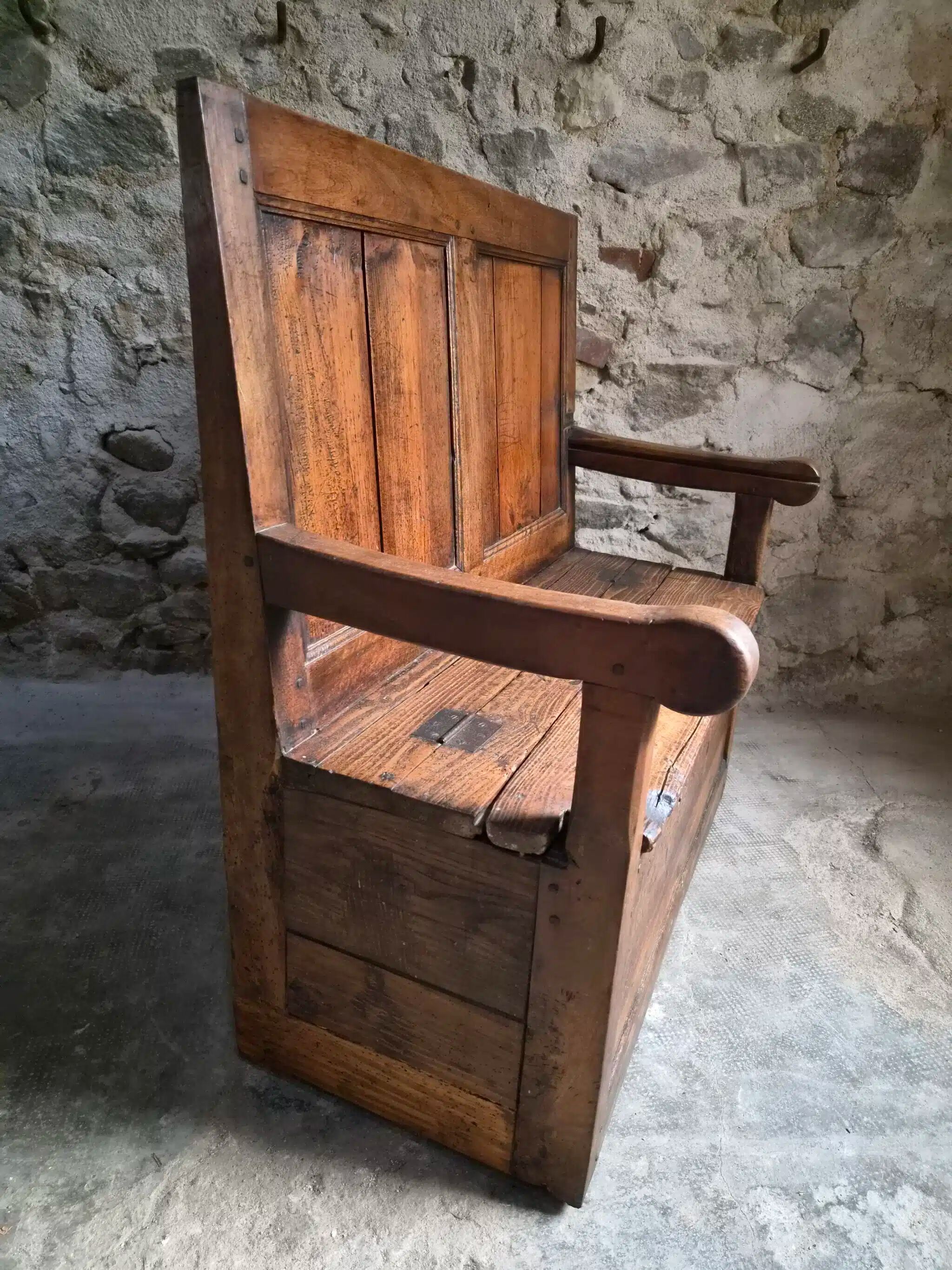 Rustic French antique storage bench from the 18th century in walnut and pine.